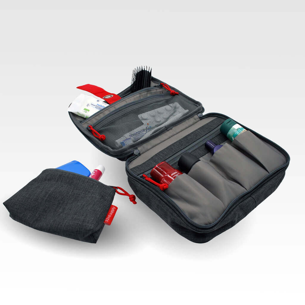 Gray toiletry bag with makeup pouch, for women. Plenty of space and compartments. Packed with products.