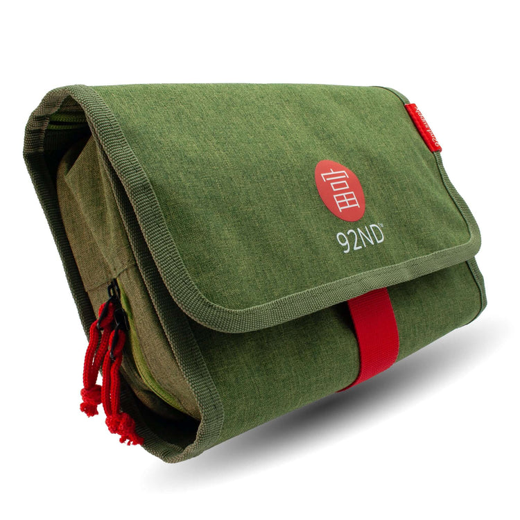 Hanging toiletry bag green – rolled up side view, compact travel size
